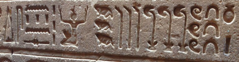 Hieroglyphs carved into a stone wall in Egypt