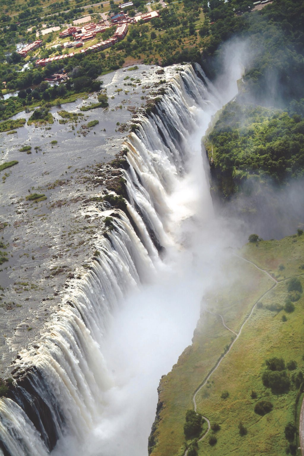Victoria Falls from above, with spray rising over green cliffs